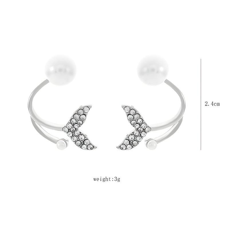 Silver open cuff bracelet with a fish design on each end studded with small diamonds and a pearl on each end.